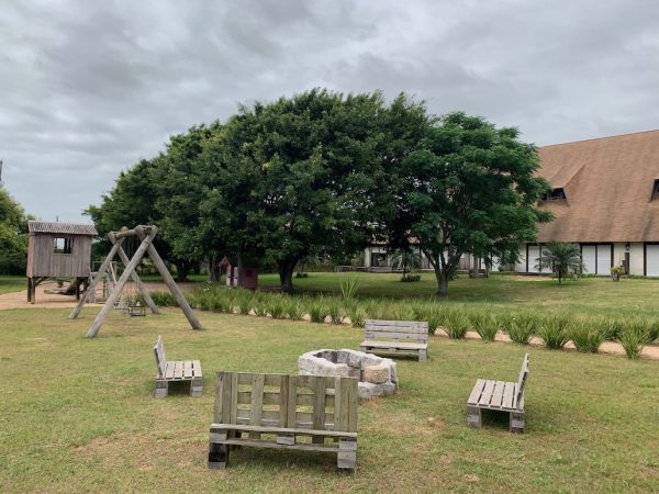 pátio externo com bancos e árvores