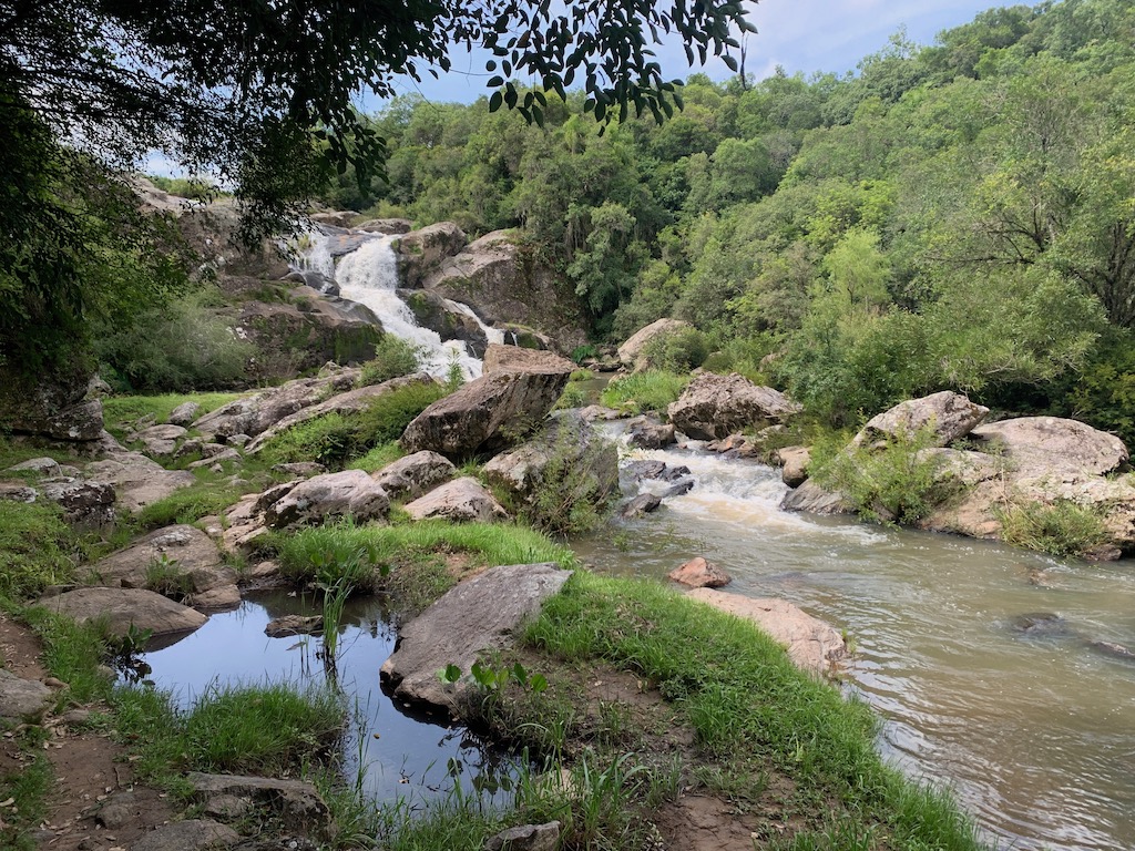 paisagem com cachoeira, pedras e árvores